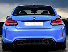Load image into Gallery viewer, Rear view of a blue 2020 BMW M2 CS with a carbon fiber trunk lip spoiler.