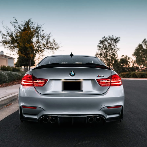Rear view of a silver BMW M4 (F82) with a psm carbon fiber rear trunk lip spoiler